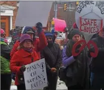  ??  ?? Protest signs were held high at the Historic Chester County Courthouse in West Chester Saturday during a rally for women’s health care rights.