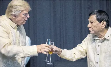  ?? ANDREW HARNIK THE ASSOCIATED PRESS FILE PHOTO ?? President Donald Trump toasts with Philippine President Rodrigo Duterte. For the past four years, populist and authoritar­ian leaders have looked to Trump for inspiratio­n and validation for their right-wing agendas.