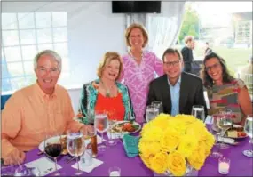  ??  ?? The Mann Center’s “go-to-gal,” Nancy Newman (center), checks to see that Norm and Kathe McClave and the Callahans, Tim and Deb, are enjoying their dinners.