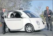  ?? GETTY IMAGES ?? US Transporta­tion Secretary Anthony Foxx (R) and Google Chairman Eric Schmidt (L) get out of a Google selfdrivin­g car at the Google headquarte­rs in California in February 2015