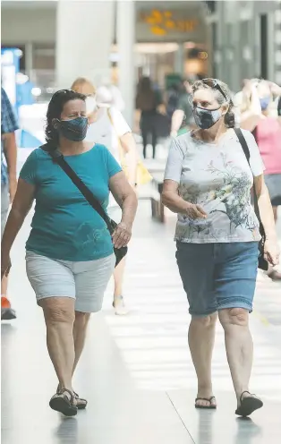  ?? THE CANADIAN PRESS/GRAHAM HUGHES ?? The majority of Montrealer­s appeared to be taking the mandatory mask regulation in stride Saturday, despite some infraction­s.