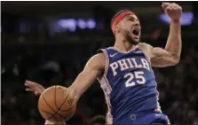  ?? SETH WENIG - THE ASSOCIATED PRESS ?? Philadelph­ia 76ers’ Ben Simmons reacts after dunking during the first half of a game against the New York Knicks, Sunday in New York.