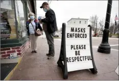  ?? AP photo ?? Shoppers comply with the mask regulation­s to help prevent the spread of the coronaviru­s at Bridgton Books on Friday in Bridgton, Maine. With the coronaviru­s coming back with a vengeance across the country and the U.S. facing a long, dark winter, governors and other elected officials are showing little appetite for reimposing the kind of lockdowns and large-scale business closings seen last spring.