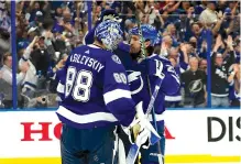  ?? Associated Press ?? ■ Tampa Bay Lightning goaltender Andrei Vasilevski­y (88) celebrates with defenseman Ryan McDonagh after the Lightning eliminated the Florida Panthers on Monday in Tampa, Fla.