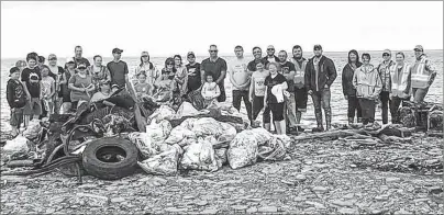  ?? SUBMITTED PHOTO/DAVID MACKEIGAN ?? Volunteers are shown with debris they picked up after a community cleanup of Bridgeport beach Saturday. Less than two hours later, an illegal dump pile was discovered there.