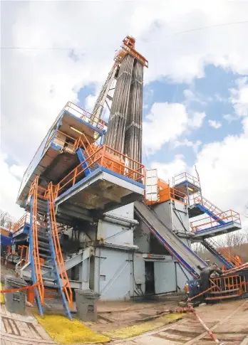  ?? KEITH SRAKOCIC/AP ?? In this photo made with a fisheye lens March 12, work continues at a shale gas well drilling site in St. Mary’s. Natural gas hydraulic fracturing, or fracking, has raised environmen­tal concerns while turning Pennsylvan­ia into a major energy producer.