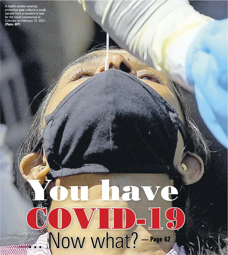  ?? (Photo: AFP) ?? A health worker wearing protective gear collects a swab sample from a resident to test for the novel coronaviru­s in Colombo on February 15, 2021.