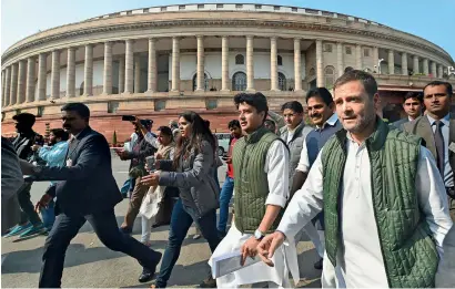  ?? PTI ?? Congress president Rahul Gandhi, with party MP Jyotiradit­ya Scindia, arrives to address the media outside parliament on Tuesday. —