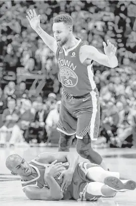  ?? Brett Coomer / Houston Chronicle ?? Rockets guard Chris Paul is knocked to the floor after he was fouled by Warriors guard Stephen Curry during the second quarter. Paul lost that battle but won the war, scoring a game-high 33 points in the victory over the Warriors.