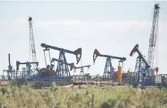  ??  ?? Pump jacks pump oil at an oil field on the shores of the Caspian Sea in Baku, Azerbaijan. — Reuters photo