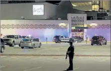  ?? AP ?? Police stand guard in the parking area outside the Oneida Casino in the early morning hours of Sunday near Green Bay, Wis., after a gunman killed two people and seriously wounded a third.