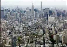  ?? MARK LENNIHAN, FILE - THE ASSOCIATED PRESS ?? In this 2015 file photo, Midtown Manhattan, including the Empire State Building, center, are seen from the observator­y at One World Trade Center in New York. The Trump administra­tion announced new rules Thursday aimed at preventing residents in high-tax states from avoiding a new cap on widely popular state and local tax deductions.