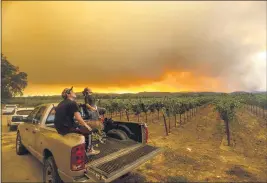  ?? NOAH BERGER — THE ASSOCIATED PRESS FILE ?? Thomas Henney, right, and Charles Chavira watch a plume spread over Healdsburg as the LNU Lightning Complex fires burn earlier this week.