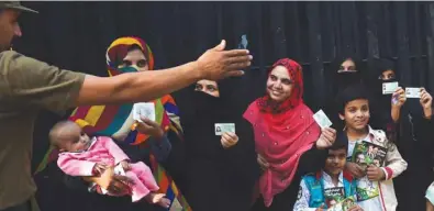  ??  ?? Women voters line up outside a polling station in Lahore during the by-election yesterday.