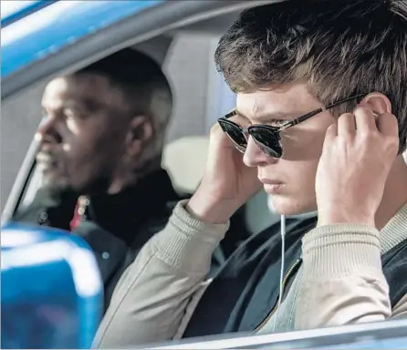  ?? Wilson Webb TriStar Pictures ?? BABY, YOU CAN DRIVE THAT CAR: Baby (Ansel Elgort, right) plugs in as he and Bats (Jamie Foxx) head to a job in the new film.