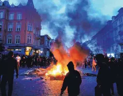  ?? MICHAEL PROBST/ASSOCIATED PRESS ?? Protesters stay between fires on a street during a protest against the G-20 summit in Hamburg, northern Germany, on Friday. The meeting started Friday and concludes today.