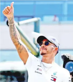  ?? — Reuters photo ?? Hamilton before the race at Silverston­e circuit in this July 8 file photo.