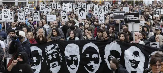  ?? ANDRE PAIN/AGENCE FRANCE-PRESSE ?? PEOPLE holding portraits of victims and banners against racism attend a protest march in commemorat­ion of the deadly 2020 Hanau shootings in Hanau, western Germany. The shootings occurred on 19 February 2020, when a gunman killed nine people by opening fire in two bars in the German city of Hanau near Frankfurt am Main.