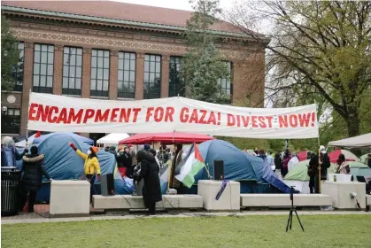  ?? Wednesday. Photograph: Anadolu/Getty Images ?? University of Michigan students protest against Israeli attacks on Gaza as they set up an encampment on campus in Ann Arbor on