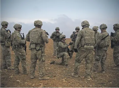  ?? AP ?? US soldiers gather for a briefing during a patrol rehearsal in Manbij, Syria, last month