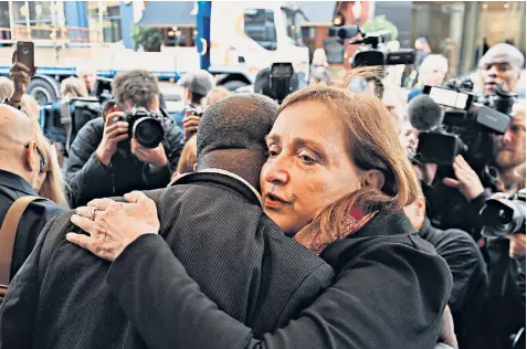  ??  ?? Emma Dent Coad, the MP for Kensington, consoles a Grenfell resident outside the inquiry, which began yesterday