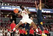  ?? ERIC CHRISTIAN SMITH — THE ASSOCIATED PRESS ?? Houston guard Jamal Shead (1) passes as West Virginia guard Noah Farrakhan defends during the second half on Saturday in Houston.