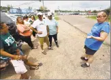  ?? Associated Press ?? Advocates confer outside the employee entrance to the Koch Foods Inc., plant in Morton, Miss., Thursday, that was raided Wednesday, by U.S. immigratio­n officials.