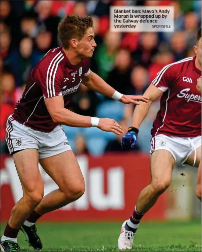 ??  ?? Blanket ban: Mayo’s Andy Moran is wrapped up by the Galway defence yesterday
