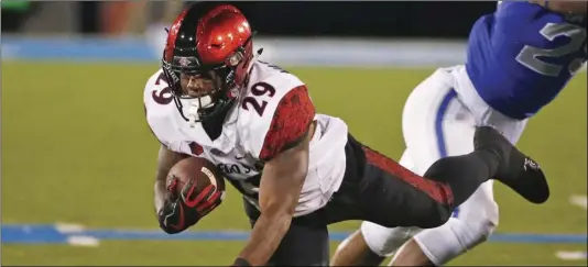  ?? AP PHOTO/JACK DEMPSEY ?? In this Sept. 23, 2017, file photo, San Diego State running back Juwan Washington is tripped up against Air Force during an NCAA college football game at Air Force Academy, Colo. Washington is ready for his turn to be San Diego State’s featured running back. If he’s as successful as D.J. Pumphrey and Rashaad Penny before him, the Aztecs will have their third straight 2,000-yard rusher.