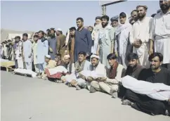  ??  ?? 0 Residents with casualties of an airstrike in Baghlan province