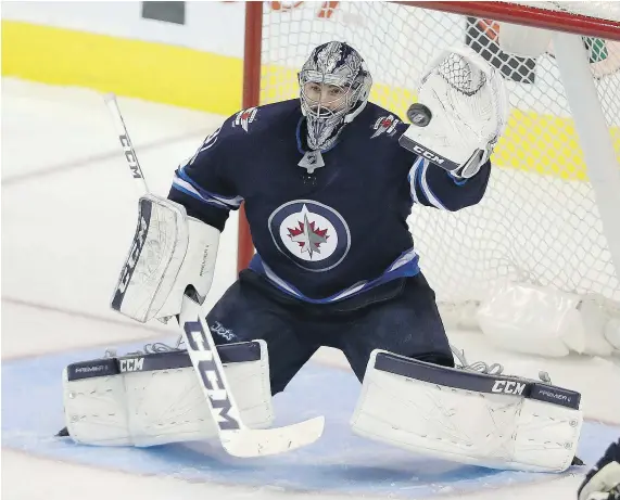  ?? — THE CANADIAN PRESS ?? Goalie Connor Hellebuyck won his third straight game Saturday as Winnipeg edged the Hurricanes 2-1 at Bell MTS Centre in the Manitoba capital. The third-year netminder made 28 saves, while Nik Ehlers scored the game-winner.