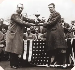  ??  ?? Samuel Ryder presents the Ryder Cup to the victorious British team captain, George Duncan, at Moortown
Golf Club in Leeds, England, 1929