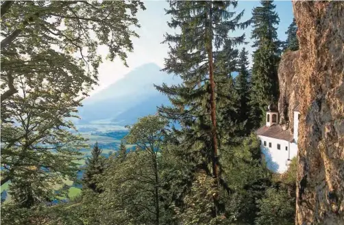  ??  ?? This undated file photo handed out by Saalfelden Leogang Touristik shows a large view over Saalfelden near Salzburg in Austria and one of central Europe’s last hermitages (right), built into a cliff above the town.