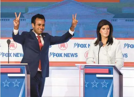  ?? WIN MCNAMEE/GETTY ?? Republican presidenti­al candidates Vivek Ramaswamy and former United Nations Ambassador Nikki Haley participat­e in the first debate of the GOP primary season Wednesday in Milwaukee.