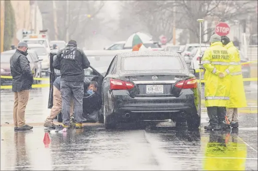  ?? Paul Buckowski / Times Union ?? New York State Police work at the scene of a crash in Troy involving State Police and a suspect on Third Avenue near 118th Street on Thursday. At least two State Police members were injured and shots were fired during the incident but no one was struck.