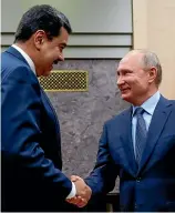  ?? AP ?? Russian President Vladimir Putin, right, shakes hands with his Venezuelan counterpar­t Nicolas Maduro during their meeting at the Novo-Ogaryovo residence outside Moscow.