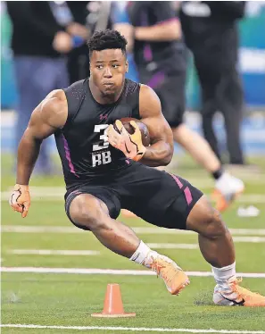  ??  ?? Running back Saquon Barkley ran a 4.40 40, posted a 41-inch vertical leap and had 29 bench press reps to make a case for being No. 1. BRIAN SPURLOCK/USA TODAY