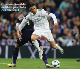  ??  ?? Cristiano Ronaldo dribbles past Toby Alderweira­ld