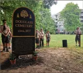  ?? HANNAH NATANSON / WASHINGTON POST ?? Sixteen-year-old Griffin Burchard (right) has been working to restore the Frederick Douglass Cemetery, a historic black cemetery in Alexandria, Virginia, that had fallen into disrepair.