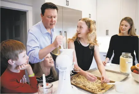  ?? Jessica Christian / The Chronicle ?? Giants broadcaste­r Dave Flemming makes homemade pasta with his family in their home in San Francisco’s Richmond District.