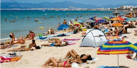  ?? Foto: Margais, dpa ?? Touristen sonnen sich am Strand von El Arenal, einem der Hauptziele für deutsche Touristen während der Sommersais­on, auf der Balearen-Insel Mallorca. „Wenn wir rauchfreie Strände und Buchten haben, wird dies für viele Urlauber ein zusätzlich­er Anreiz sein“, sagte Maria Ramos vom Ministeriu­m für den Gesundheit­sschutz.