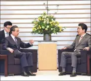  ?? MA PING / XINHUA ?? State Councilor and Foreign Minister Wang Yi meets with Japanese Prime Minister Shinzo Abe in Tokyo on Monday.