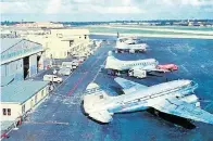  ?? Courtesy Miami Air Internatio­nal ?? An undated photo shows a 1920s-era Pan American Airways hangar, at left, one of the original buildings at what is now Miami Internatio­nal Airport.