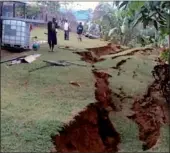  ?? FRANCIS AMBROSE VIA REUTERS ?? Residents stand next to a damaged house near a landslide in the town of Tari on Tuesday after an earthquake hit Papua New Guinea’s Southern Highlands on Monday.