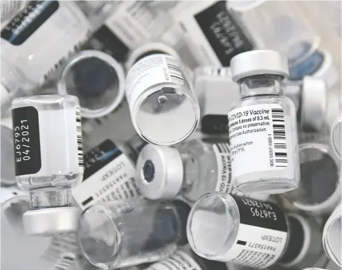  ?? EBASTIEN BOZON / AFP VIA GETTY IMAGES FILE PHOTO ?? Empty bottles of Pfizer-biontech COVID-19 vaccine.