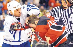  ?? KEVIN FRAYER/THE CANADIAN PRESS VIA AP FILE ?? Toronto’s Tie Domi, left, punches New Jersey’s Jay Pandolfo in a game in 2006. Enforcers are finding their jobs have become outdated in a faster, leaner era of play.