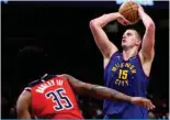  ?? ?? WASHINGTON: Nikola Jokic #15 of the Denver Nuggets shoots in front of Marvin Bagley III #35 of the Washington Wizards during the second half at Capital One Arena on January 21, 2024 in Washington. — AFP