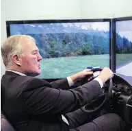  ?? CHRIS YOUNG / THE CANADIAN PRESS FILES ?? Bill Blair sits a driving simulator meant to mimic the effects of driving under the influence of cannabis.
