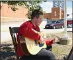  ??  ?? Collin Arkenburg of Willoughby entertains shoppers at the outdoor market June 24.