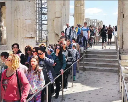  ?? RICK STEVES ?? In Athens, cruise passengers line up in the Parthenon. Arrive at tourist sites late in the afternoon to avoid the usual midday rush.